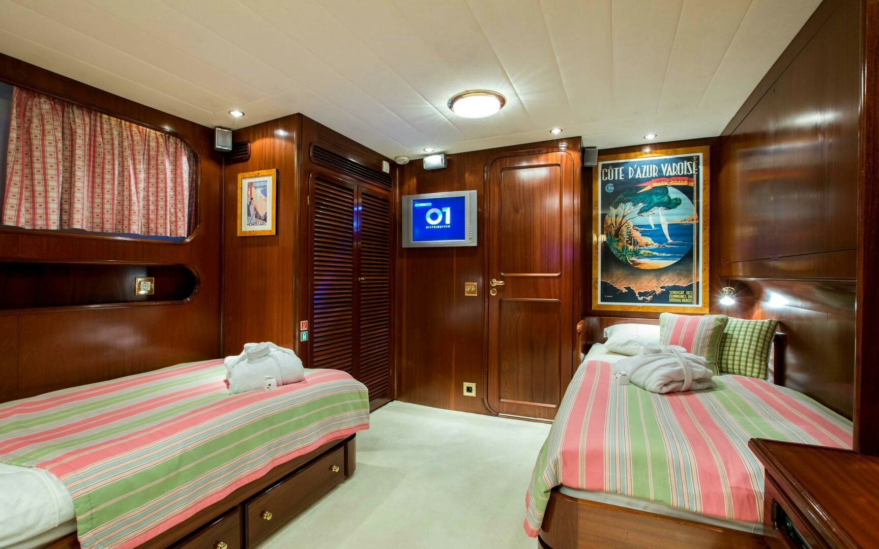 a room with a bed and a tv on the wall aboard STAR OF THE SEA Yacht for Sale