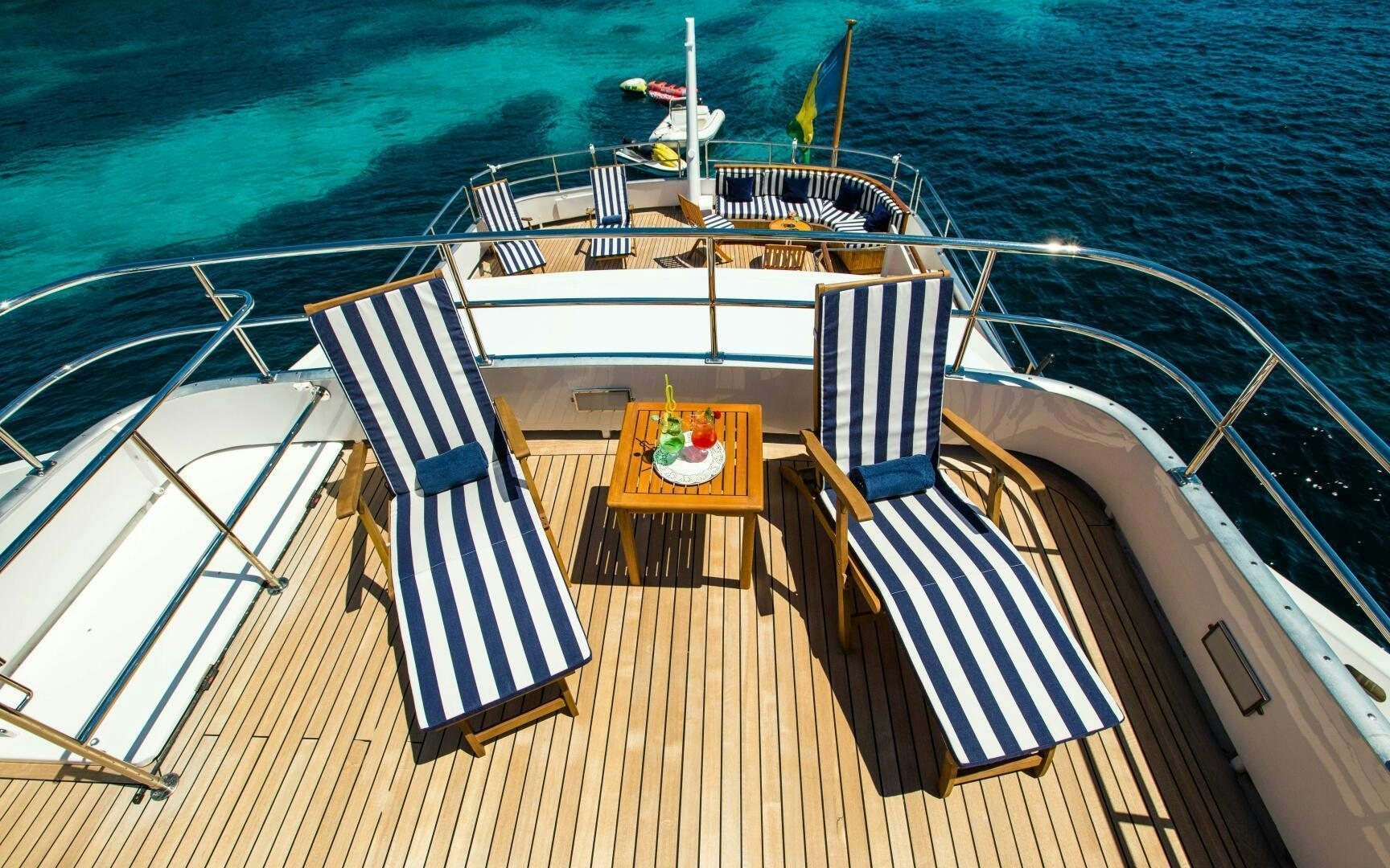 a deck with a table and chairs on it aboard STAR OF THE SEA Yacht for Sale