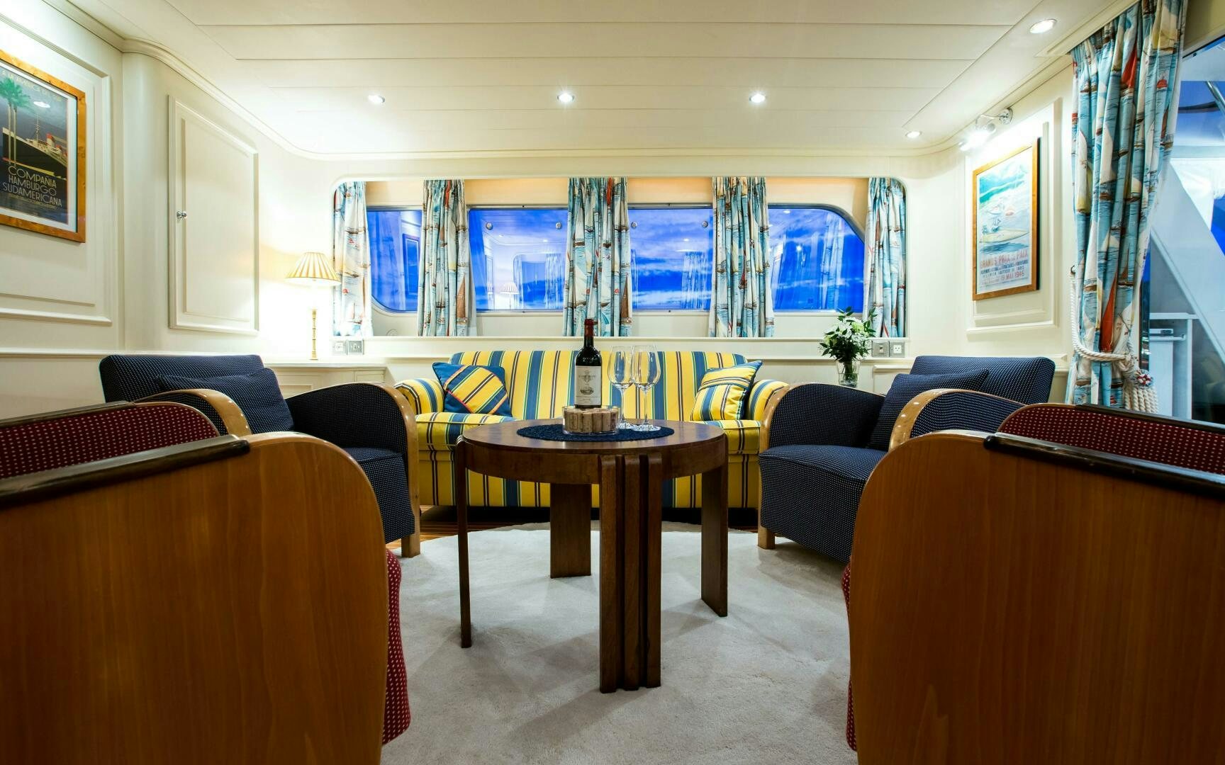 a room with a table and couches aboard STAR OF THE SEA Yacht for Sale