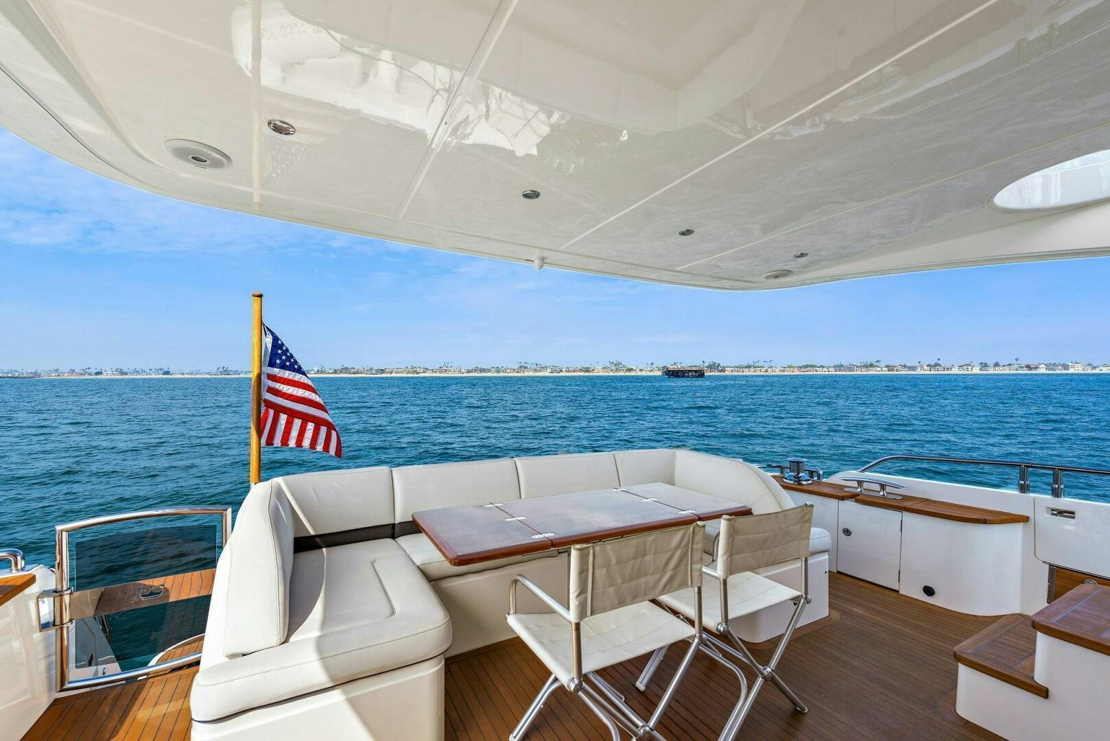 a boat with a flag on the deck aboard LA-Z-BUOY Yacht for Sale