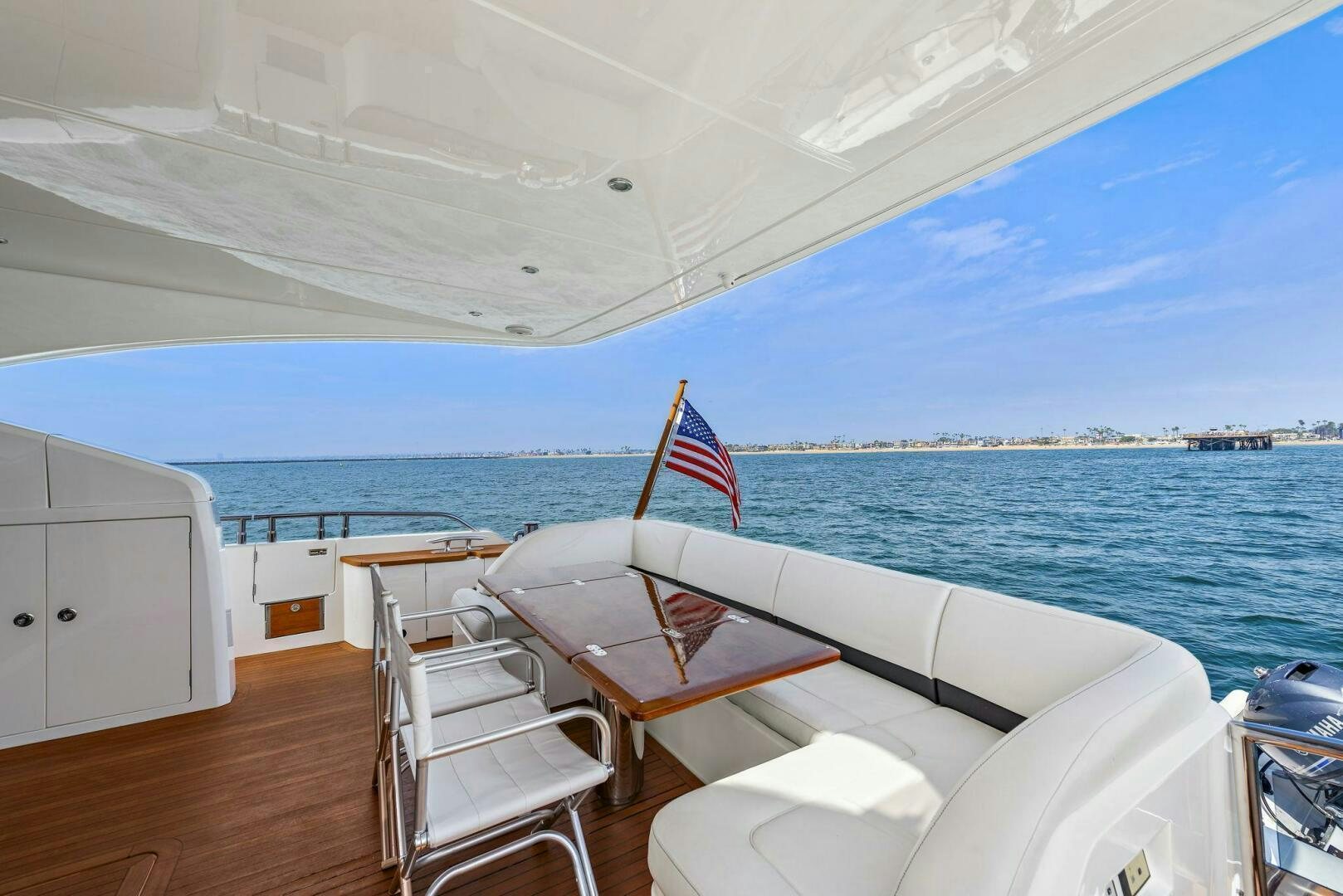 a boat with chairs and a flag on the deck aboard LA-Z-BUOY Yacht for Sale