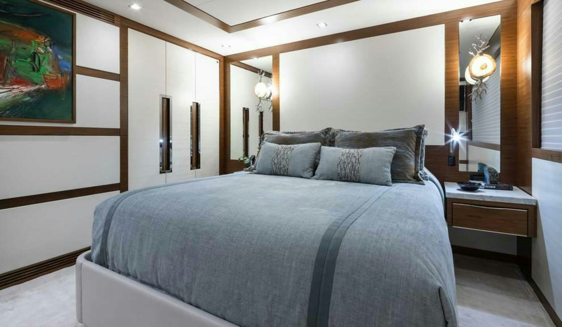 a bed with a blue comforter aboard NORTHLAND Yacht for Sale