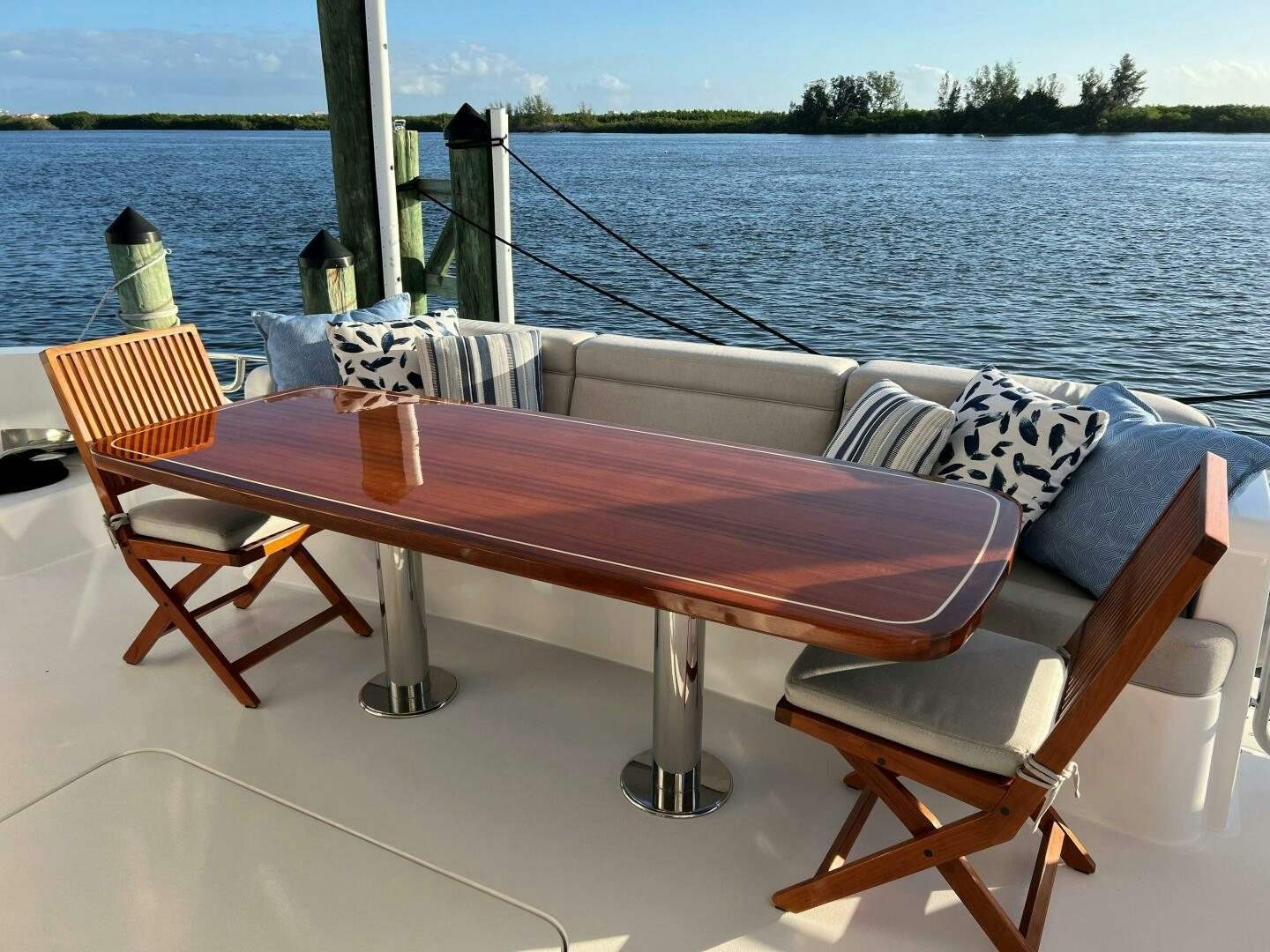 a table and chairs on a boat aboard HAPPY HEART Yacht for Sale