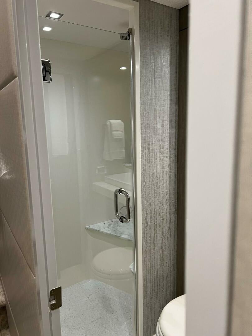 a bathroom with a glass shower aboard HAPPY HEART Yacht for Sale