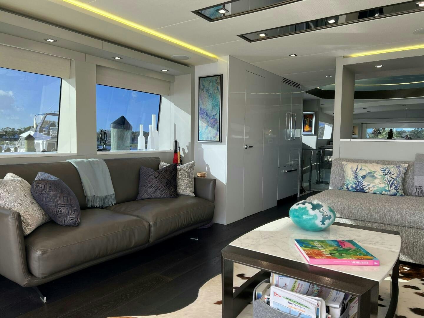 a living room with a couch and a coffee table aboard HAPPY HEART Yacht for Sale
