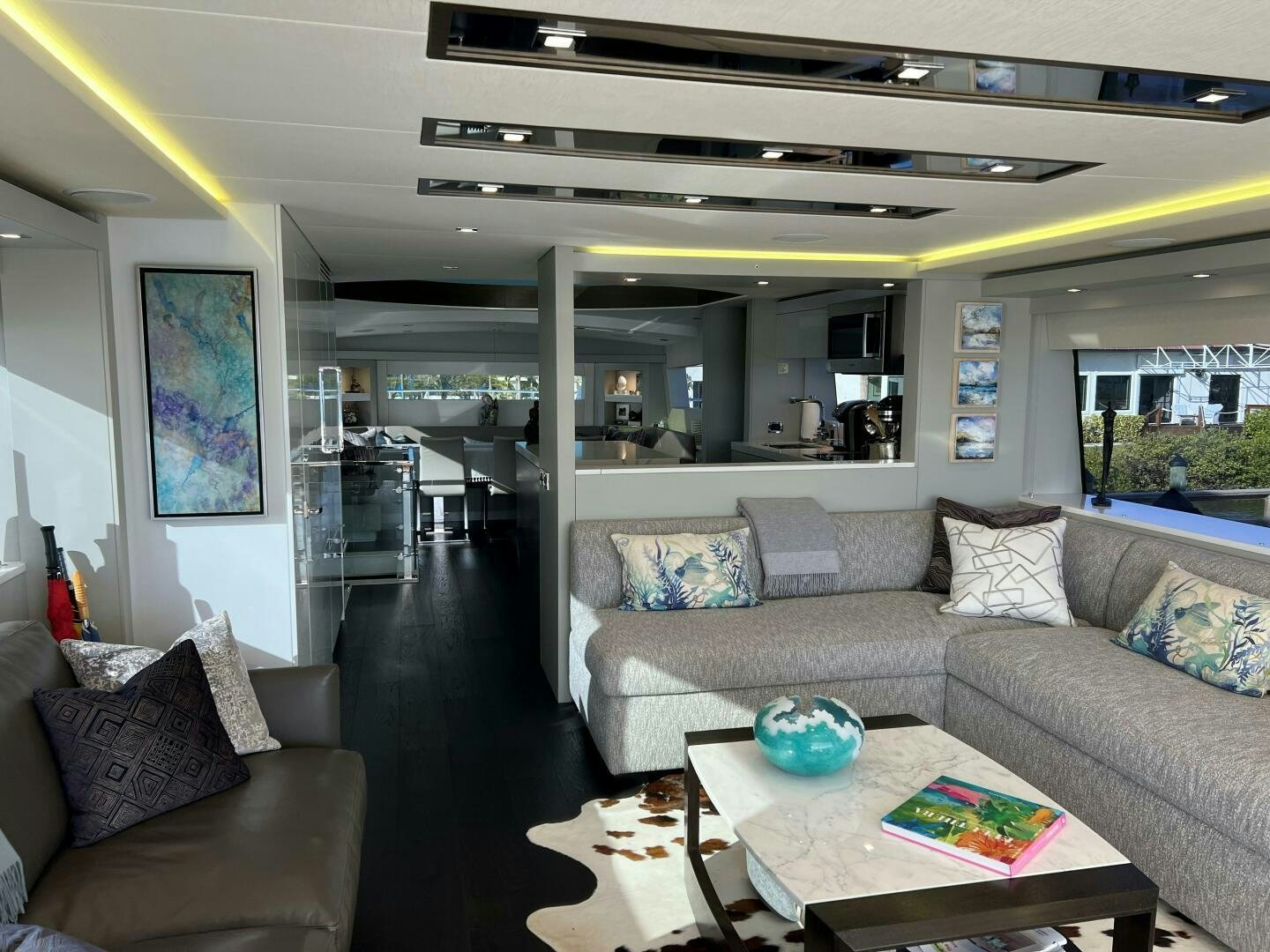 a living room with a couch and a table aboard HAPPY HEART Yacht for Sale