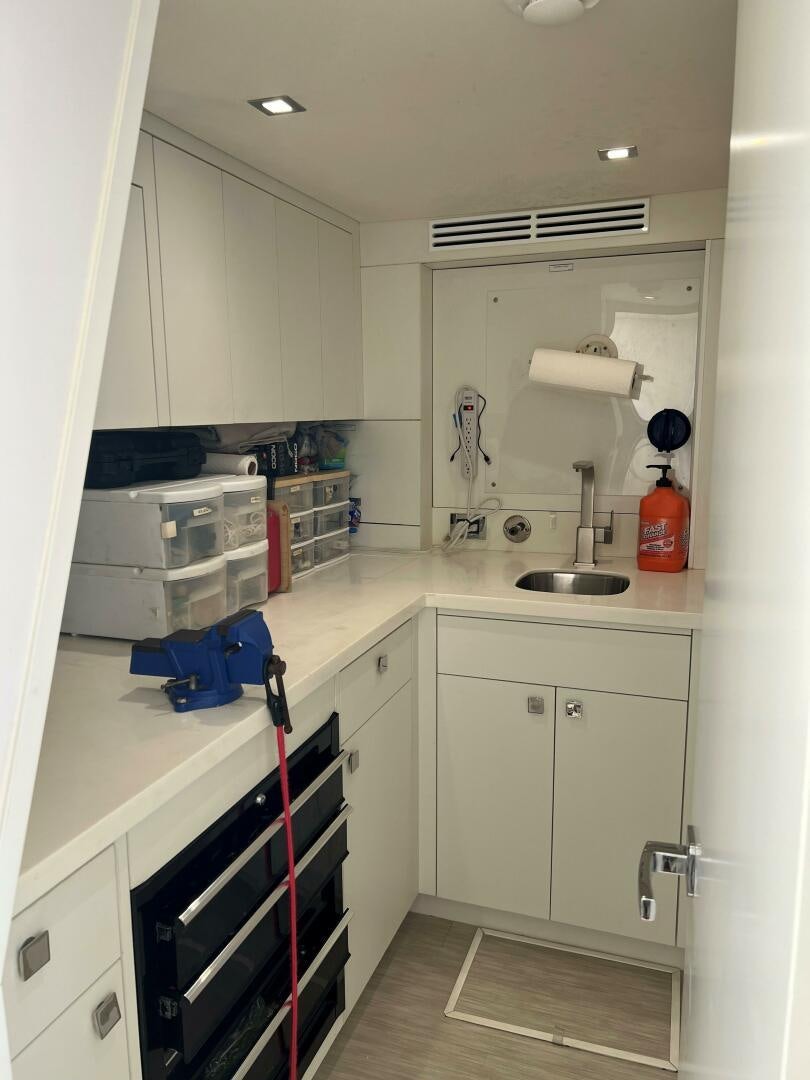 a kitchen with white cabinets aboard HAPPY HEART Yacht for Sale