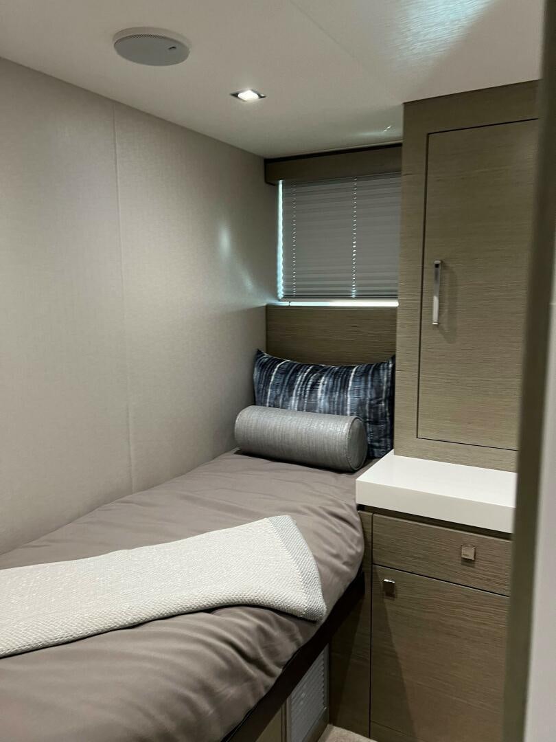 a bedroom with a bed and a window aboard HAPPY HEART Yacht for Sale