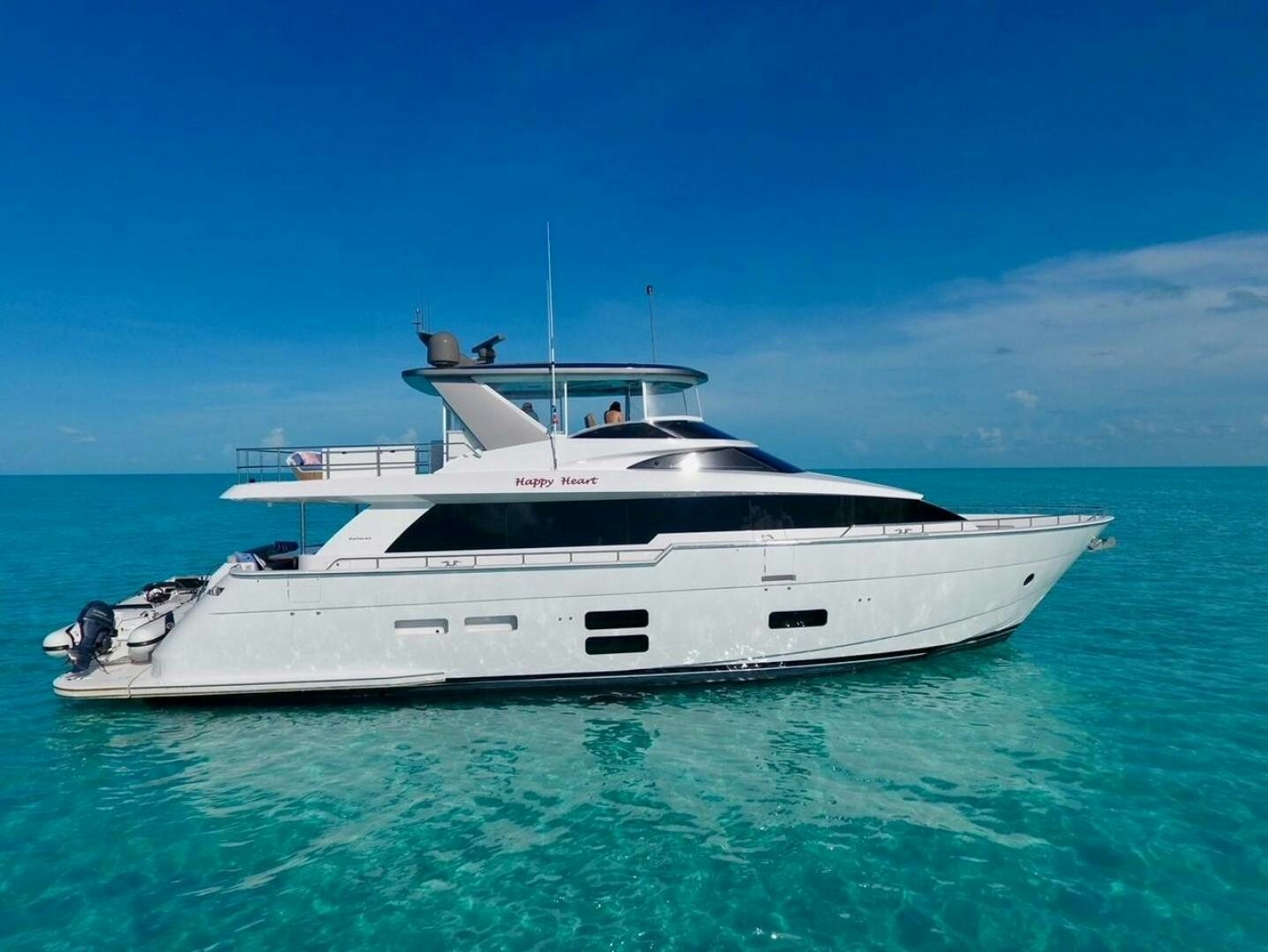 a white yacht in the water aboard HAPPY HEART Yacht for Sale