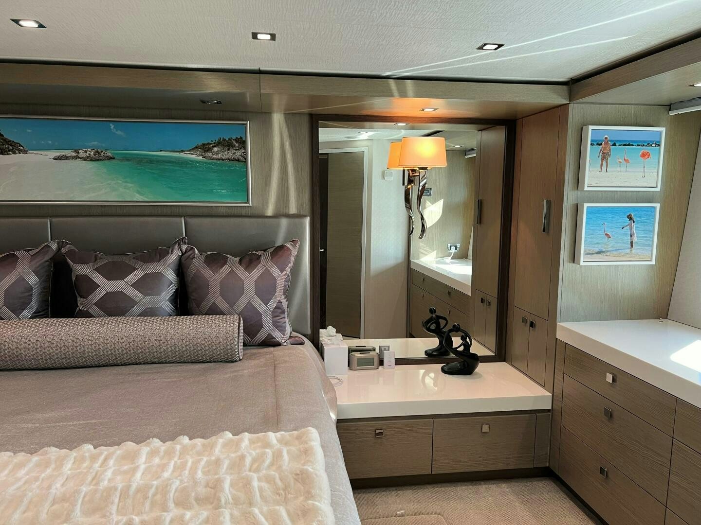 a bedroom with a large mirror aboard HAPPY HEART Yacht for Sale
