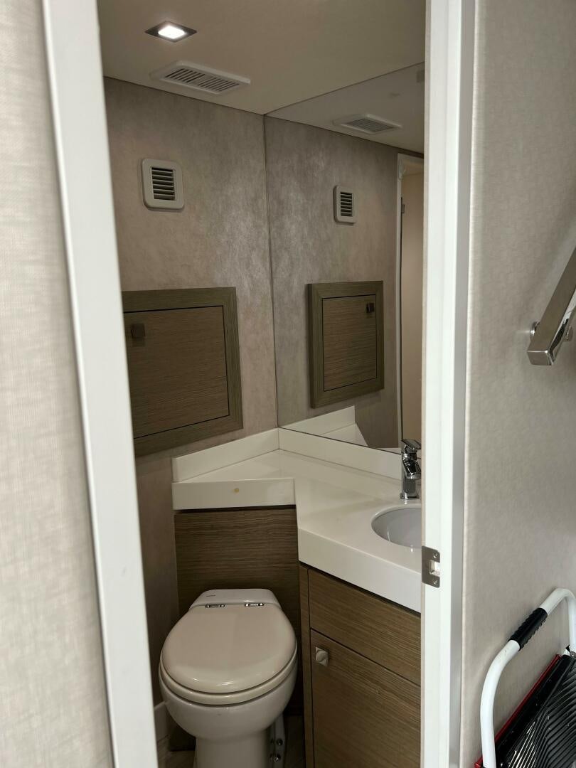 a bathroom with a toilet and sink aboard HAPPY HEART Yacht for Sale