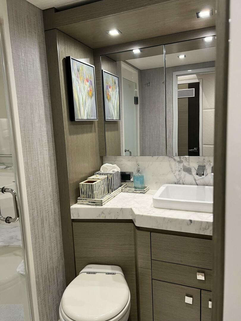a bathroom with a mirror and a sink aboard HAPPY HEART Yacht for Sale