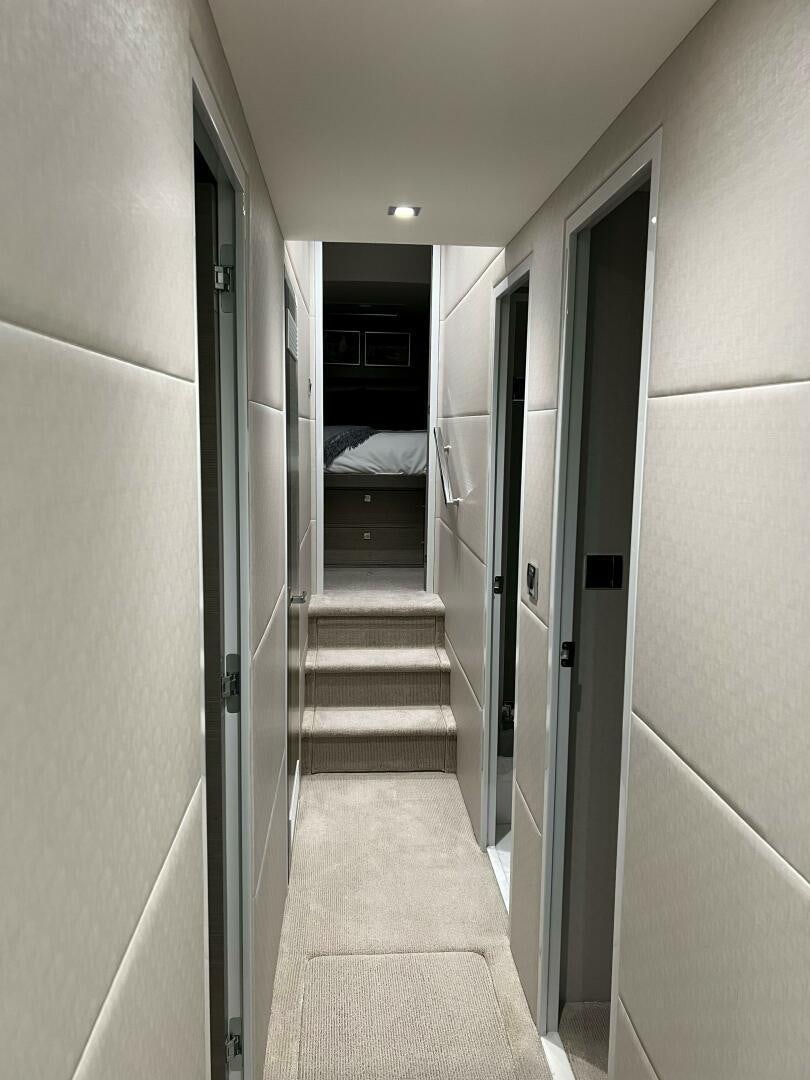 a hallway with white walls aboard HAPPY HEART Yacht for Sale