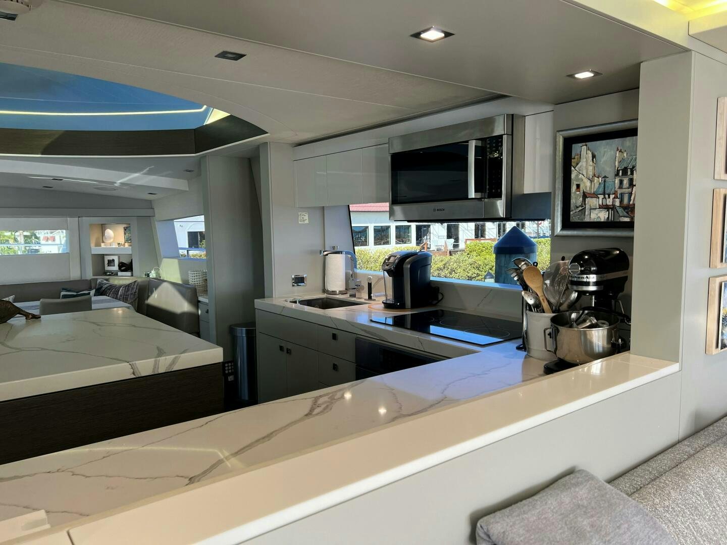 a kitchen with a large window aboard HAPPY HEART Yacht for Sale