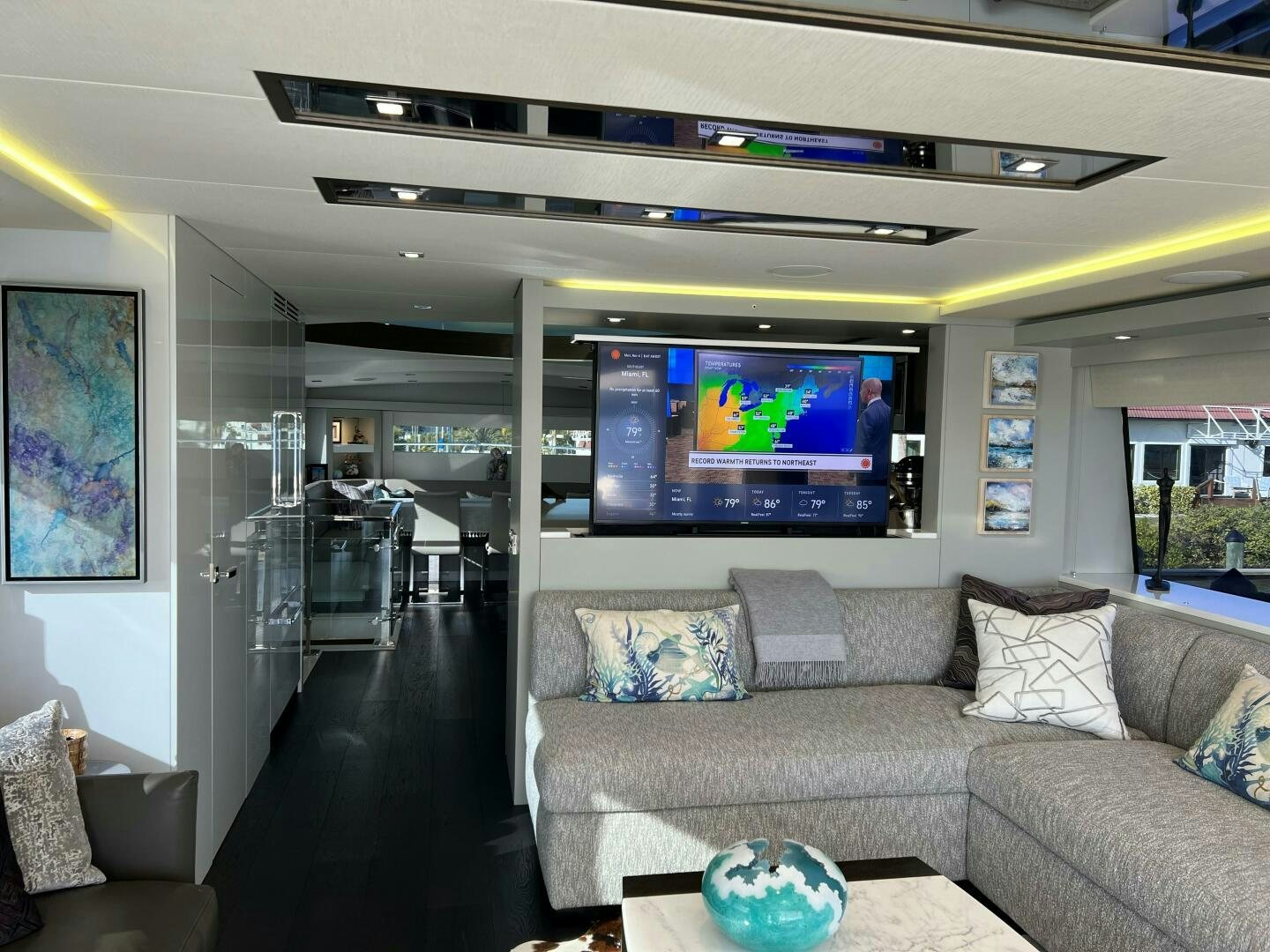 a living room with a large screen aboard HAPPY HEART Yacht for Sale