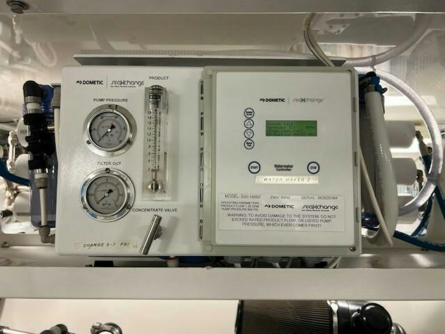 a white machine with a green label aboard HAPPY HEART Yacht for Sale