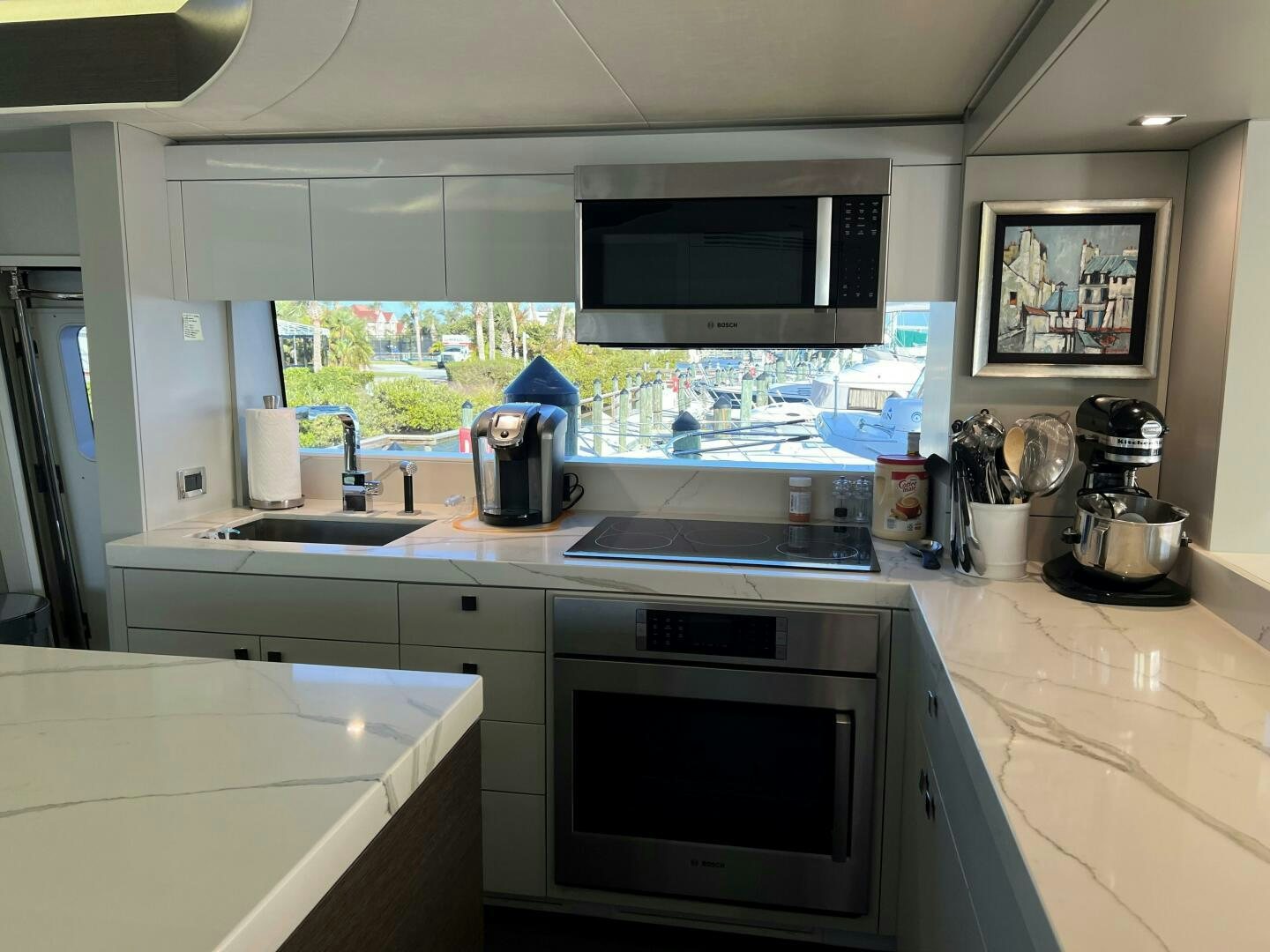 a kitchen with a large glass window aboard HAPPY HEART Yacht for Sale