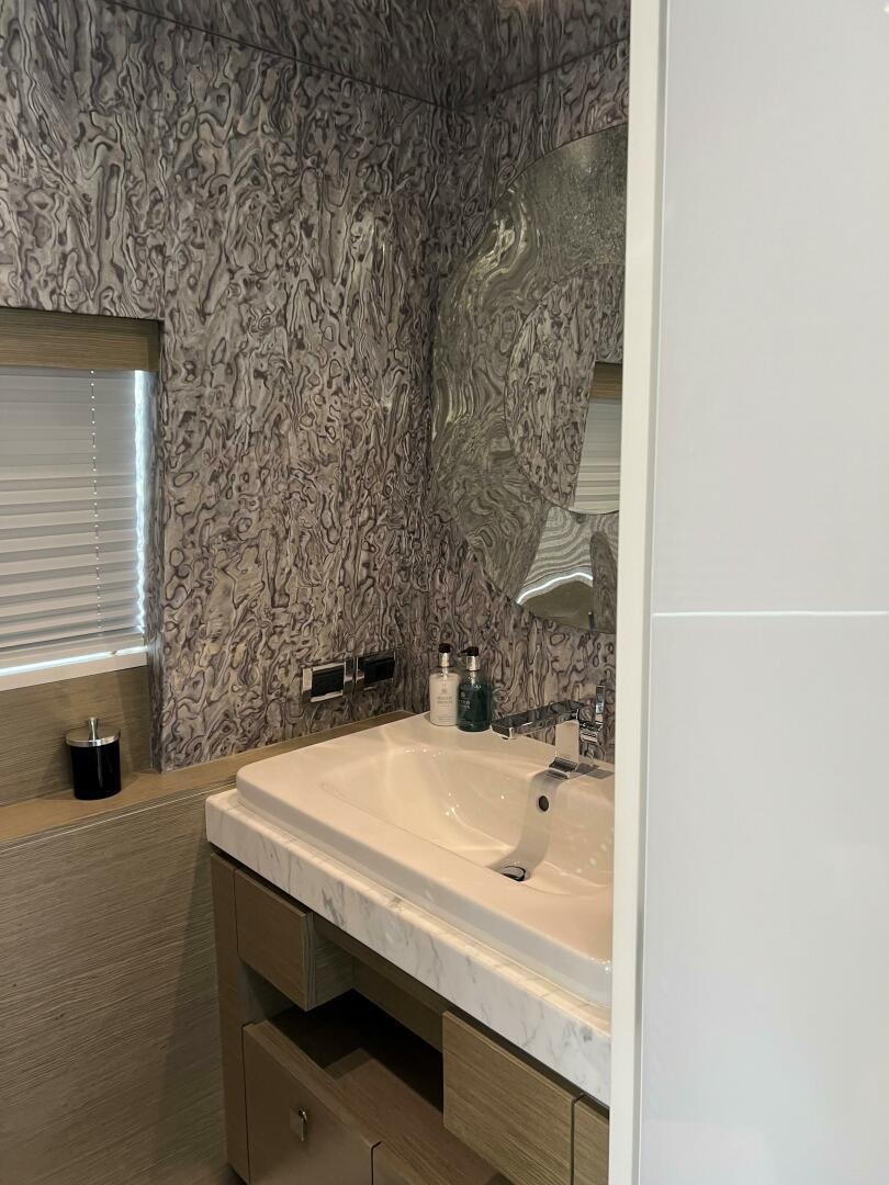 a bathroom with a sink and a mirror aboard HAPPY HEART Yacht for Sale