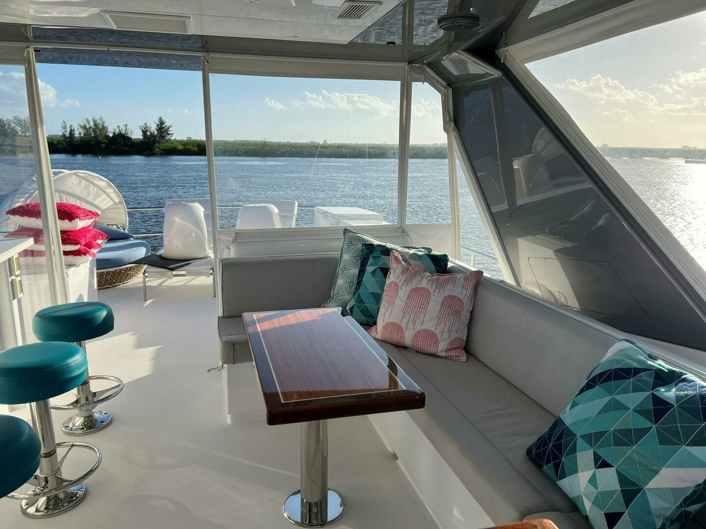 a room with a couch and a table and chairs aboard HAPPY HEART Yacht for Sale
