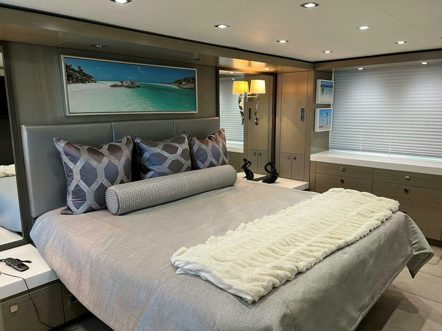 a bed with a white comforter aboard HAPPY HEART Yacht for Sale