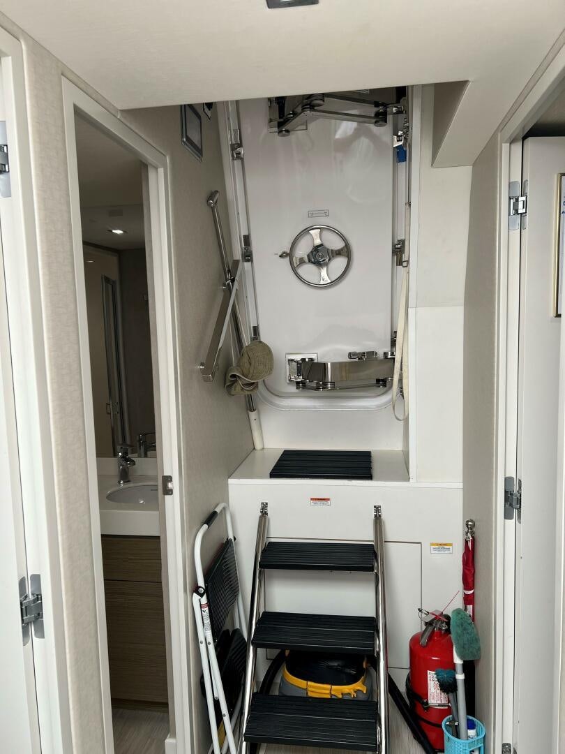 a white sink and a mirror in a room aboard HAPPY HEART Yacht for Sale