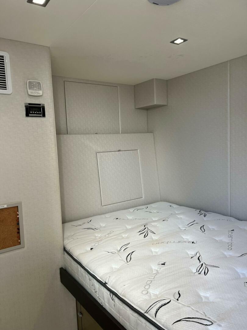 a bed with white sheets aboard HAPPY HEART Yacht for Sale