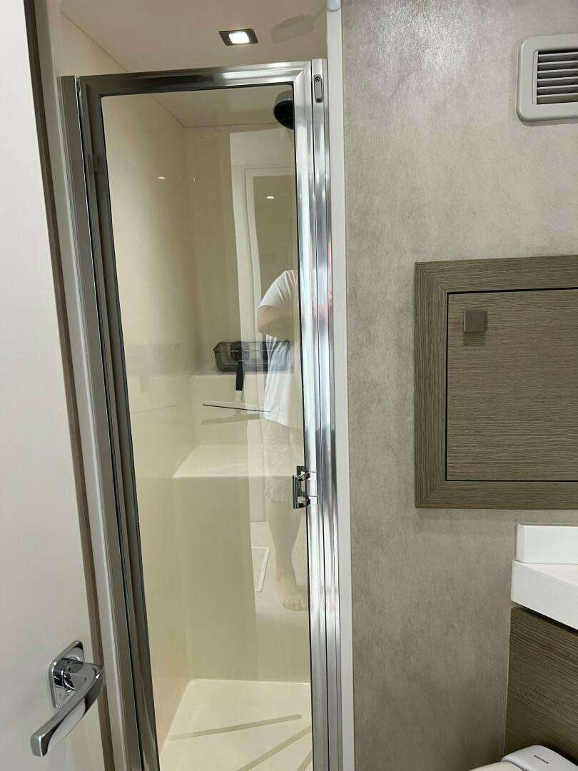 a bathroom with a glass shower aboard HAPPY HEART Yacht for Sale