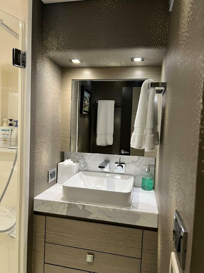 a bathroom with a sink and mirror aboard HAPPY HEART Yacht for Sale