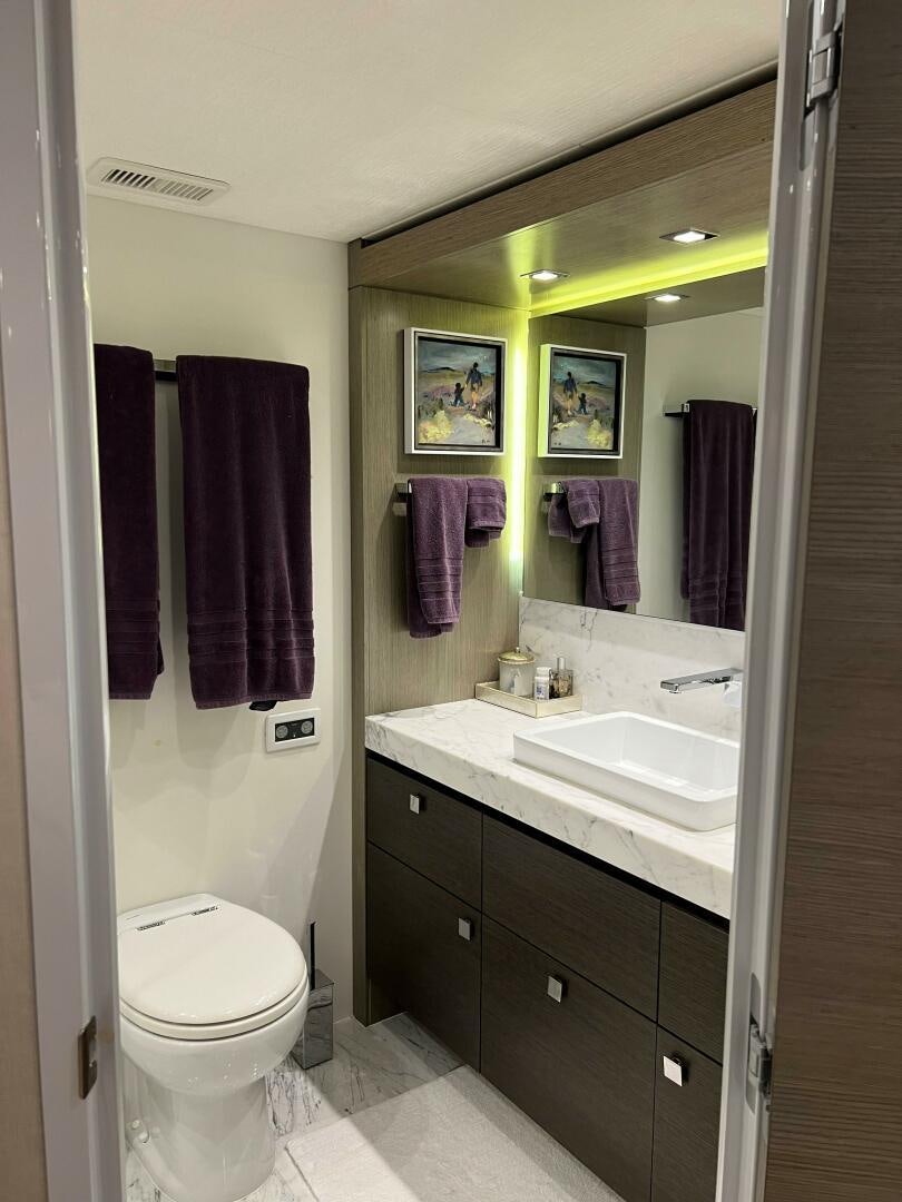 a bathroom with a sink and a toilet aboard HAPPY HEART Yacht for Sale