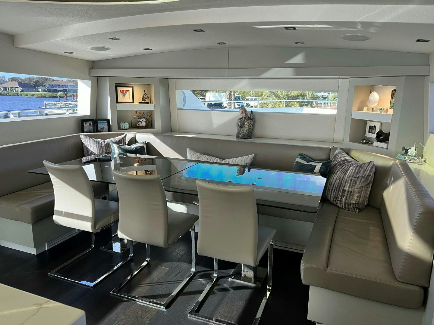 a living room with a large sofa and a large screen aboard HAPPY HEART Yacht for Sale