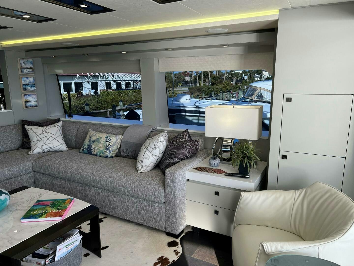 a living room with a large window aboard HAPPY HEART Yacht for Sale