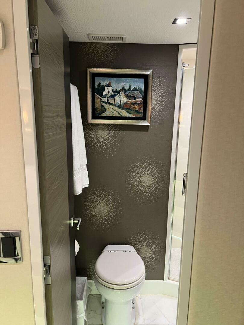 a bathroom with a picture on the wall aboard HAPPY HEART Yacht for Sale