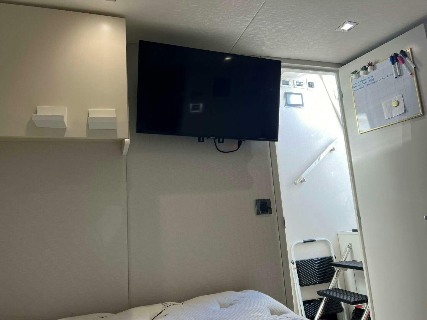 a room with a tv and a bed aboard HAPPY HEART Yacht for Sale