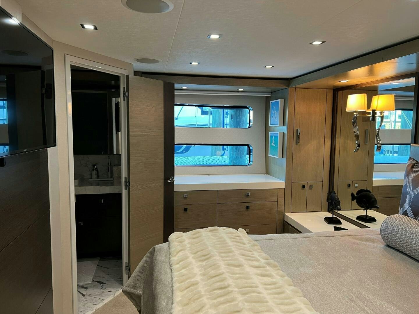a bedroom with a bed and a closet aboard HAPPY HEART Yacht for Sale