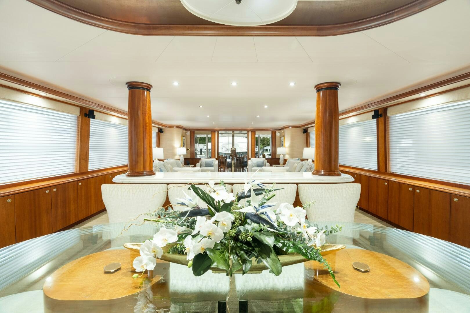 a vase of white flowers on a table aboard ELYSIAN Yacht for Sale