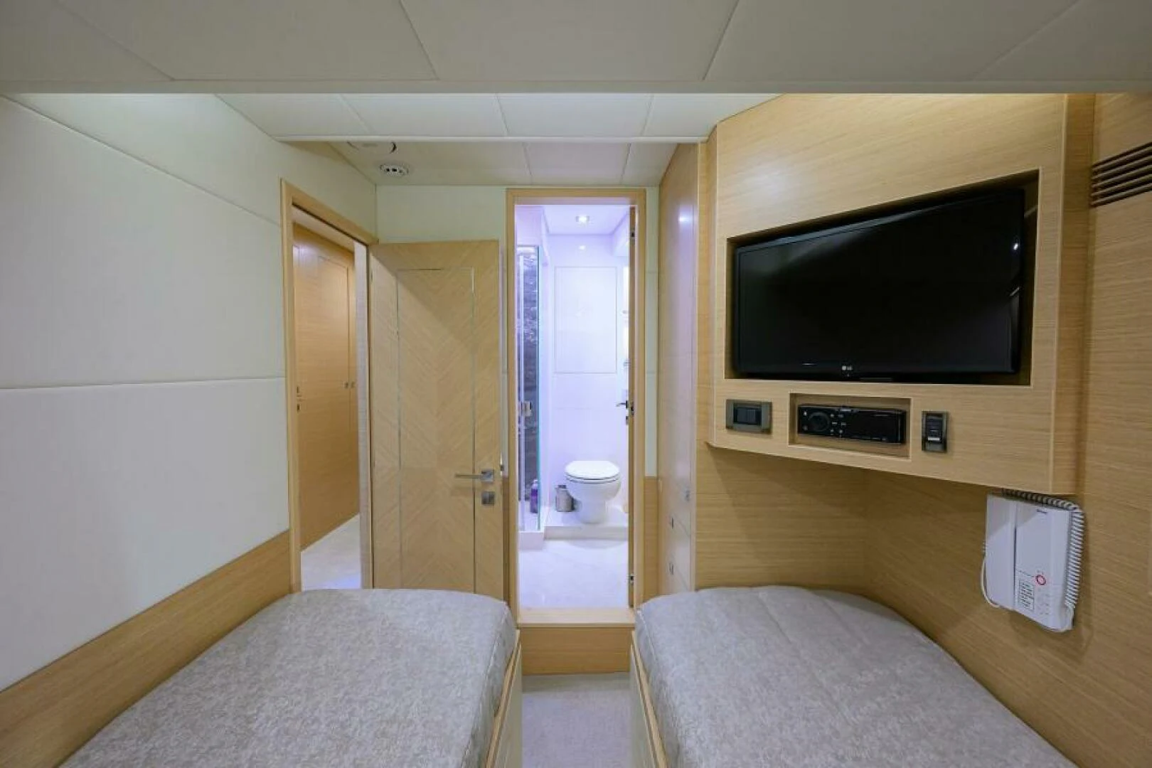 a bedroom with a tv and a bed aboard JOURNEY Yacht for Sale