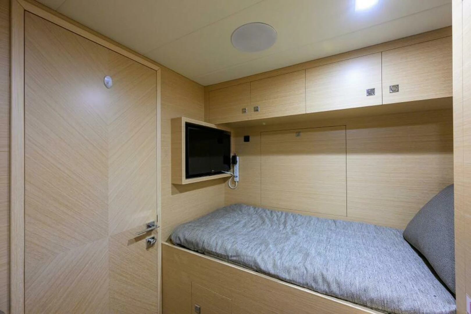 a bedroom with a bed and a television aboard JOURNEY Yacht for Sale