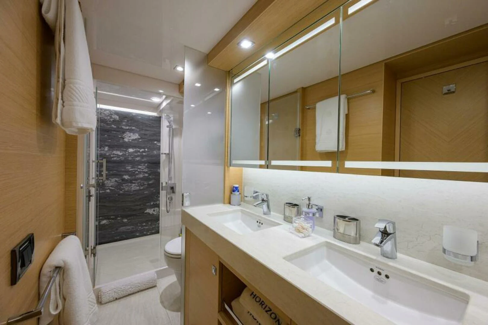 a bathroom with a large mirror aboard JOURNEY Yacht for Sale