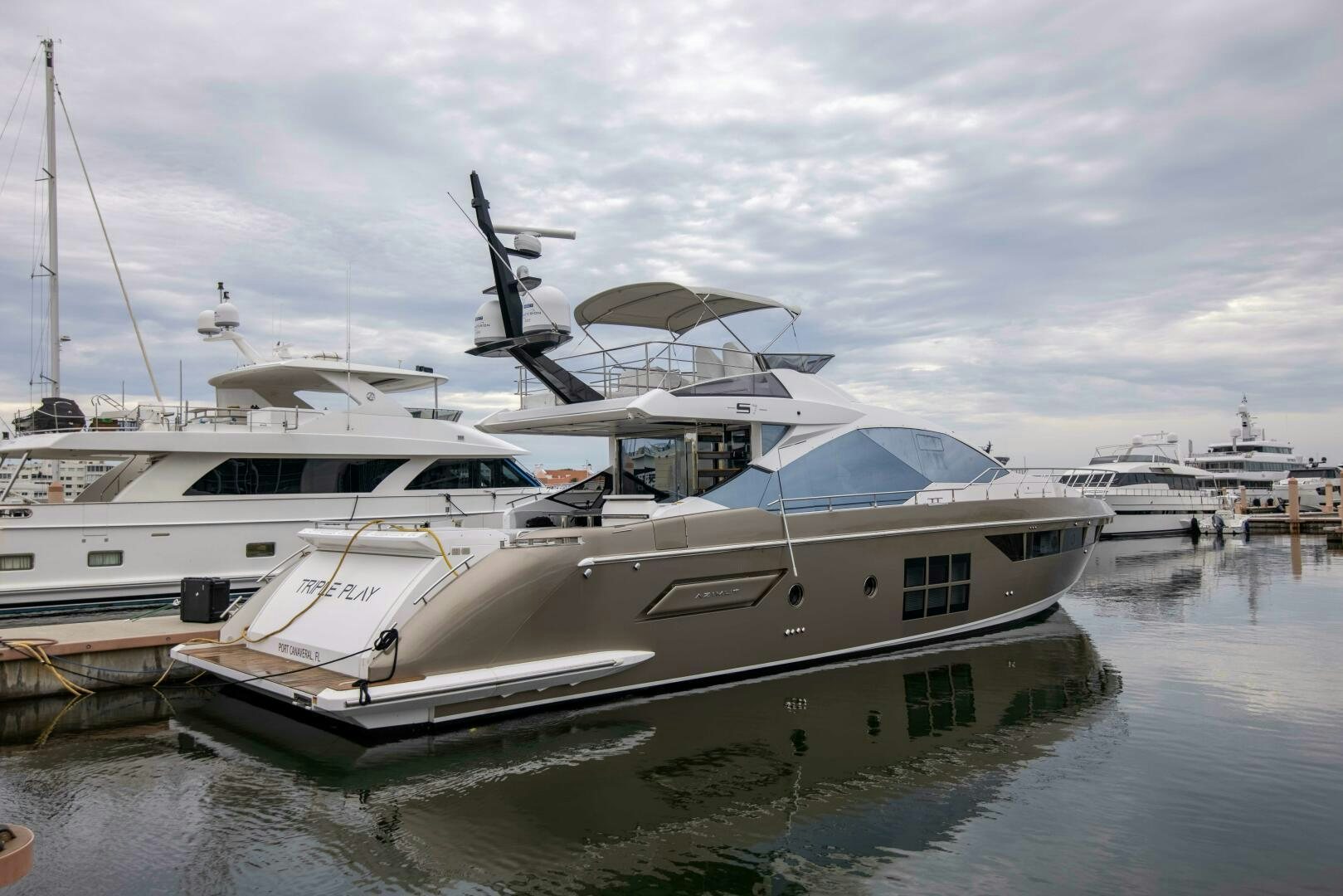 a boat docked at a pier aboard TRIPLE PLAY Yacht for Sale