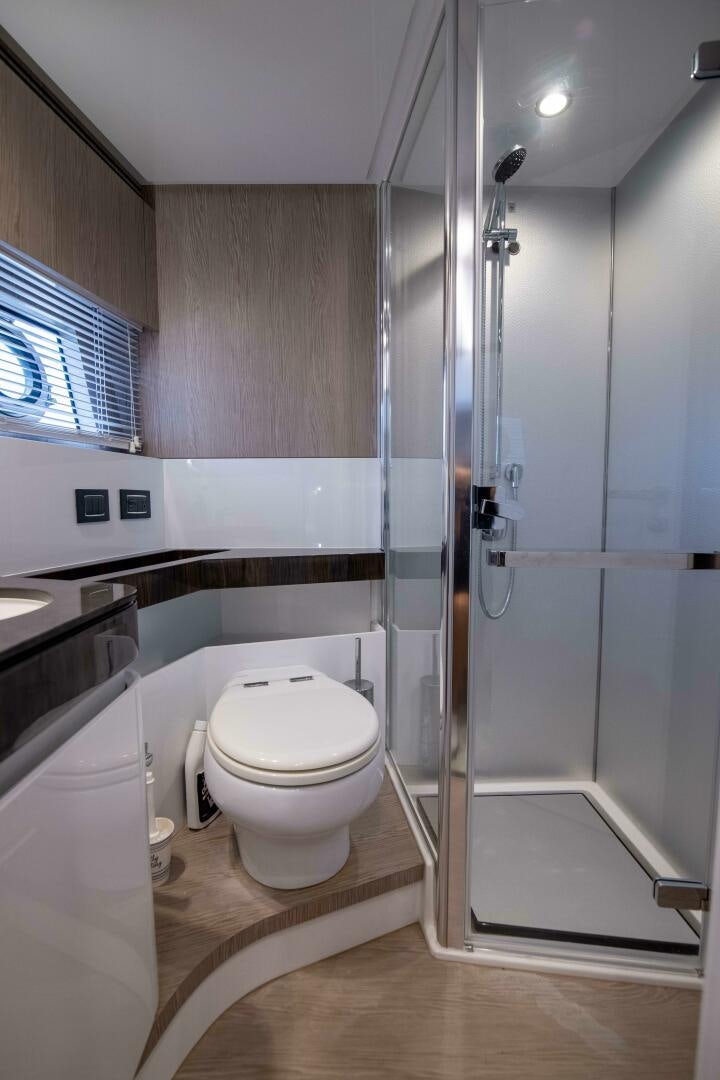 a bathroom with a shower unit and a toilet aboard TRIPLE PLAY Yacht for Sale