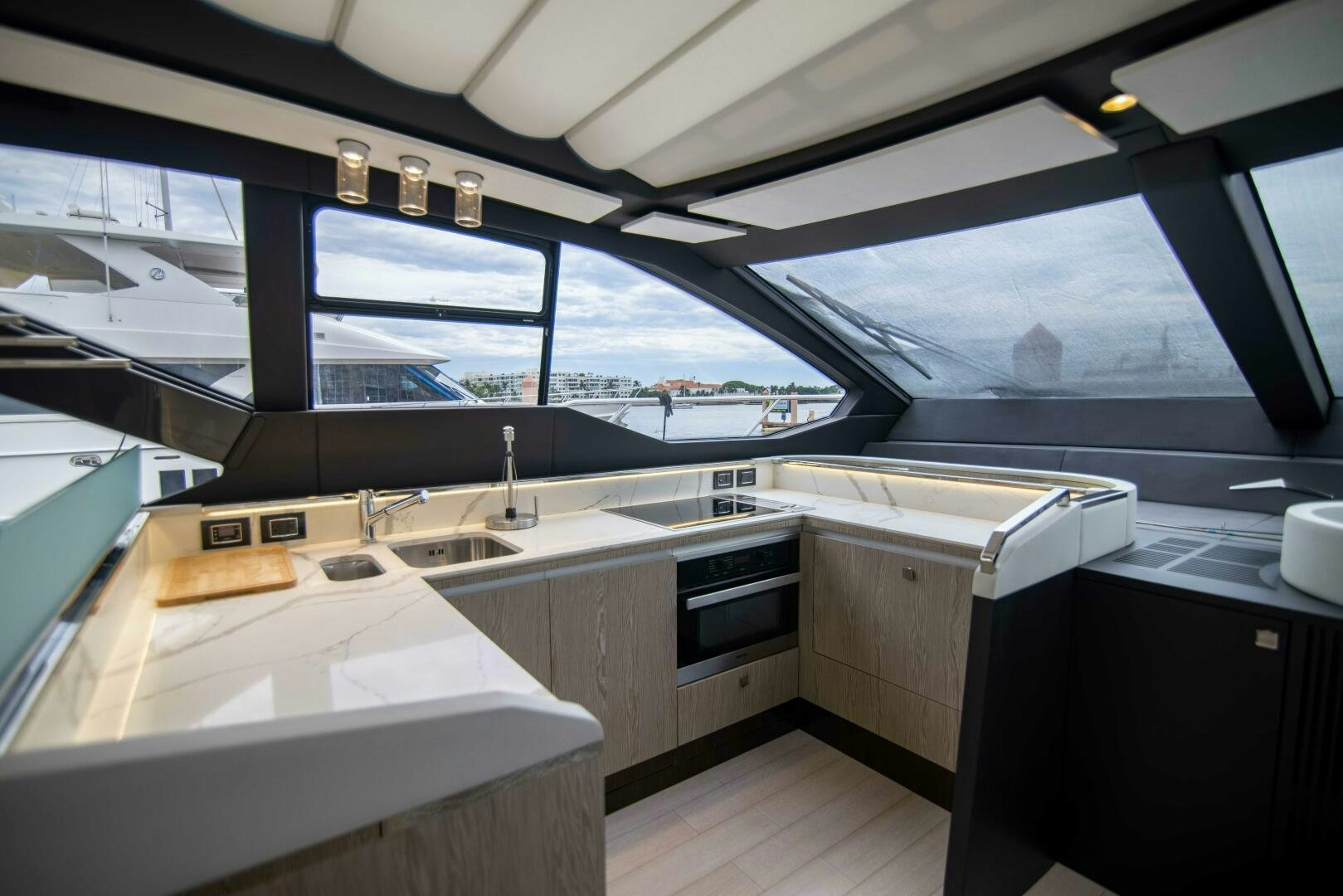 a kitchen with a view of the water aboard TRIPLE PLAY Yacht for Sale