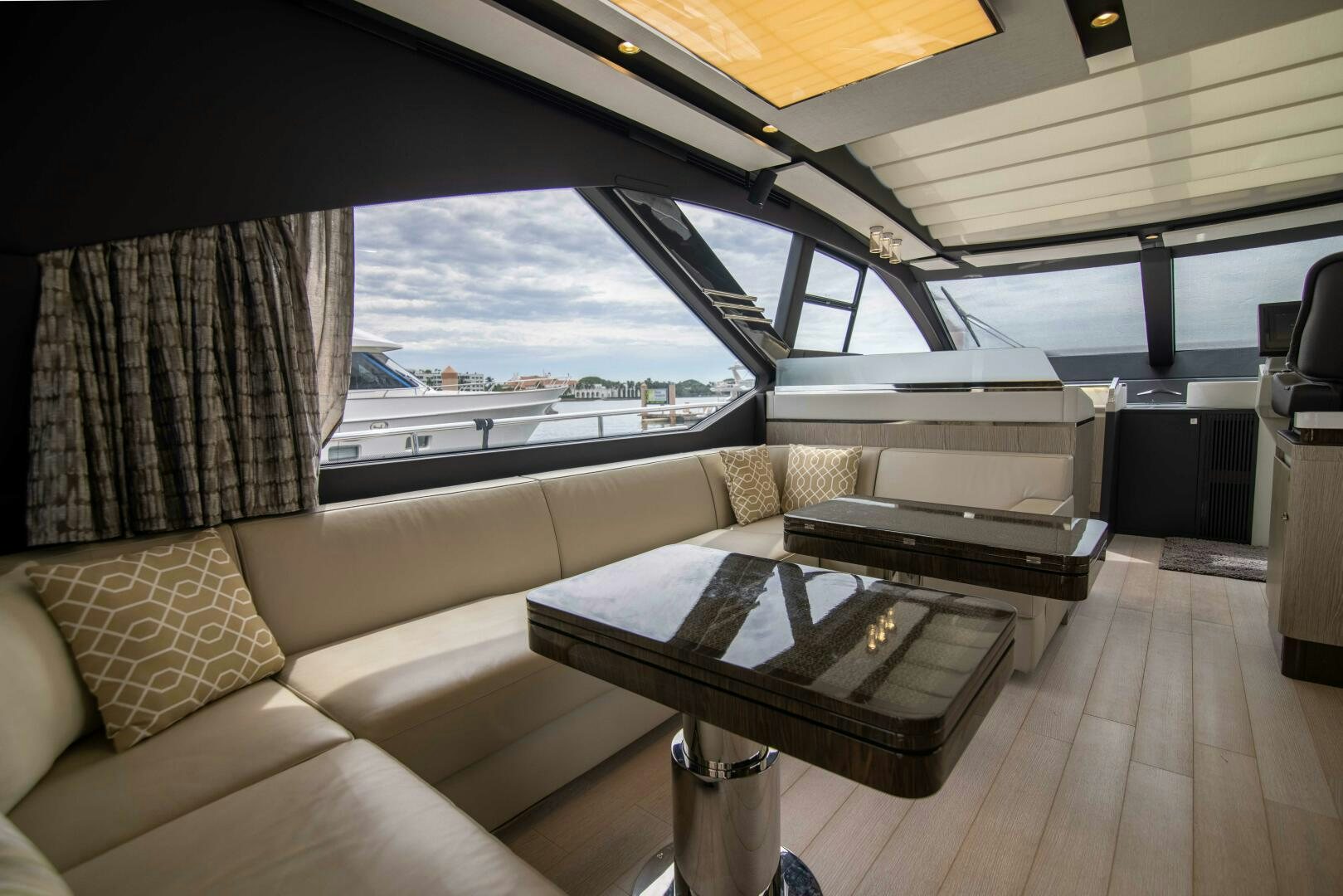 a room with a couch and a table and a window aboard TRIPLE PLAY Yacht for Sale