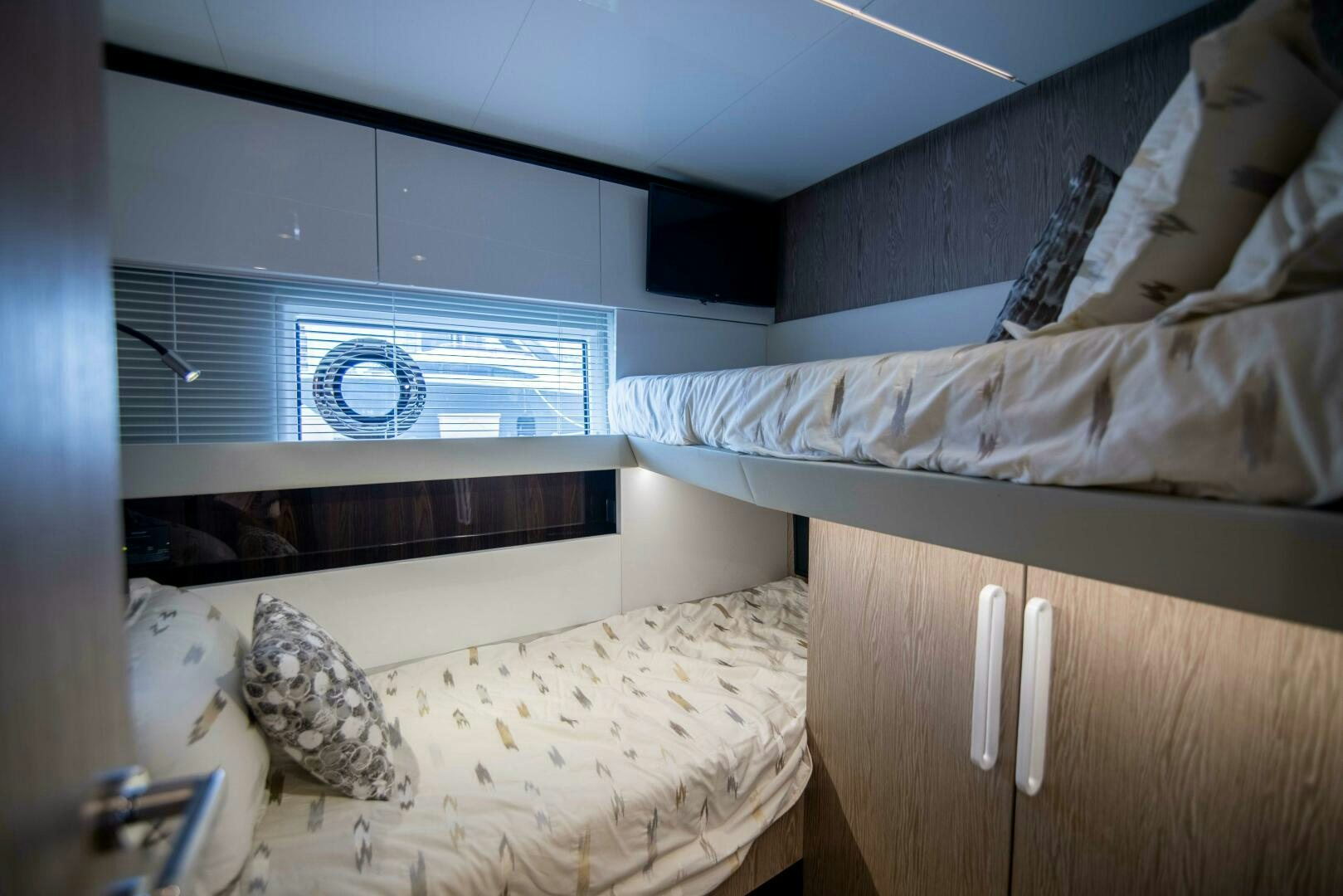 a bedroom with a bed and a window aboard TRIPLE PLAY Yacht for Sale