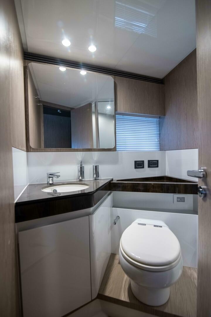 a bathroom with a large mirror aboard TRIPLE PLAY Yacht for Sale