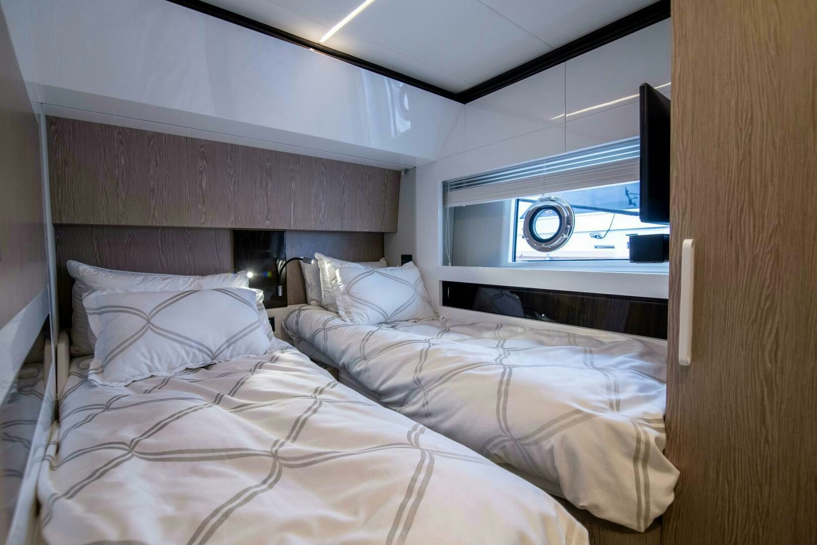 a room with two beds aboard TRIPLE PLAY Yacht for Sale