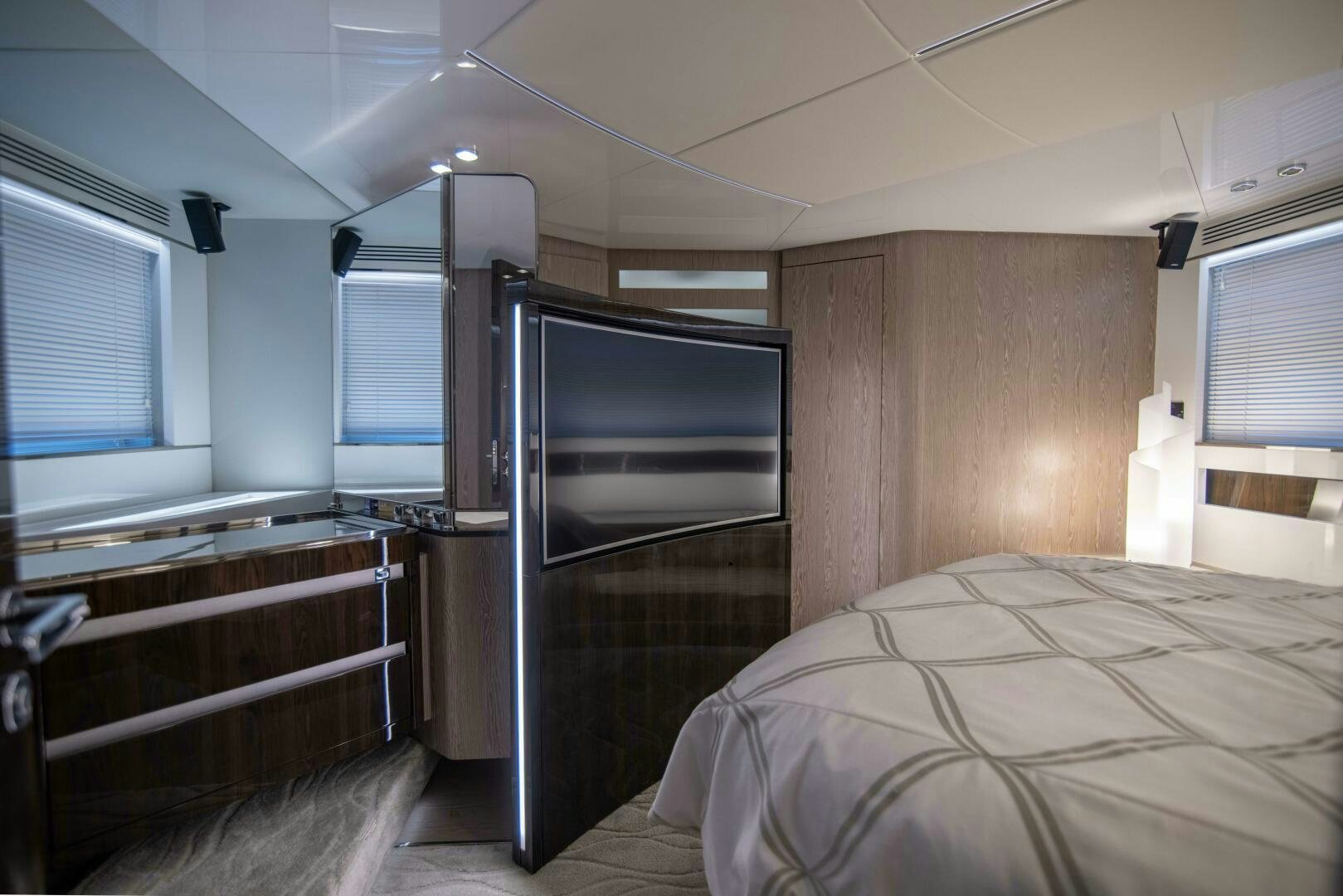 a bedroom with a bed and a tv aboard TRIPLE PLAY Yacht for Sale