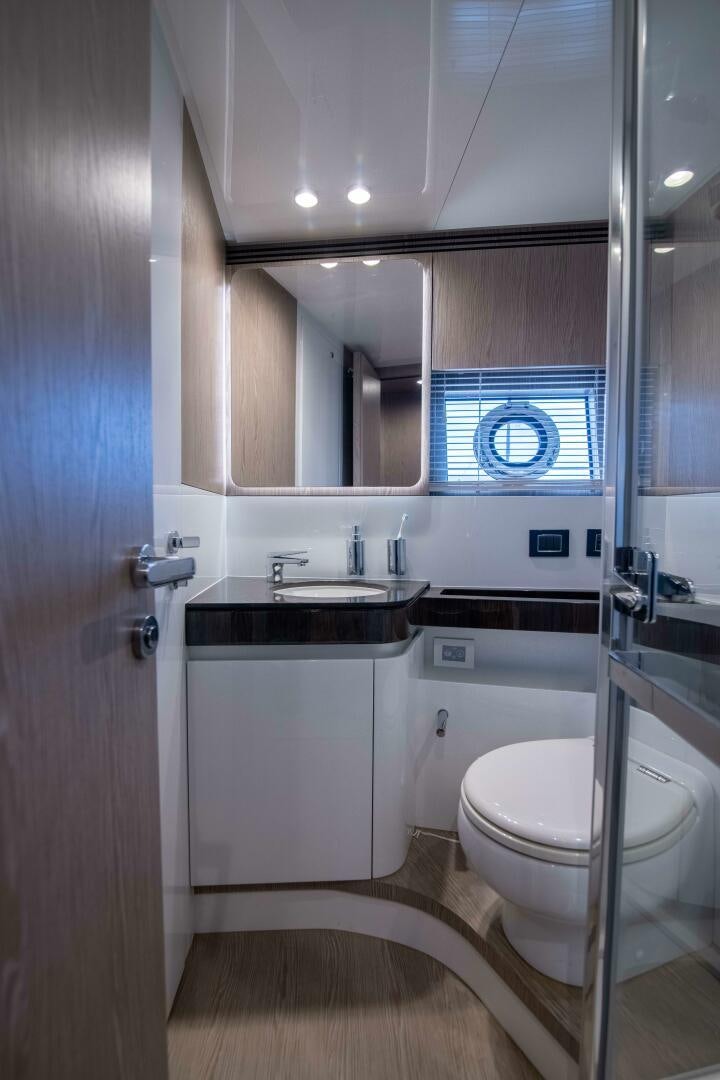 a bathroom with a sink and a toilet aboard TRIPLE PLAY Yacht for Sale
