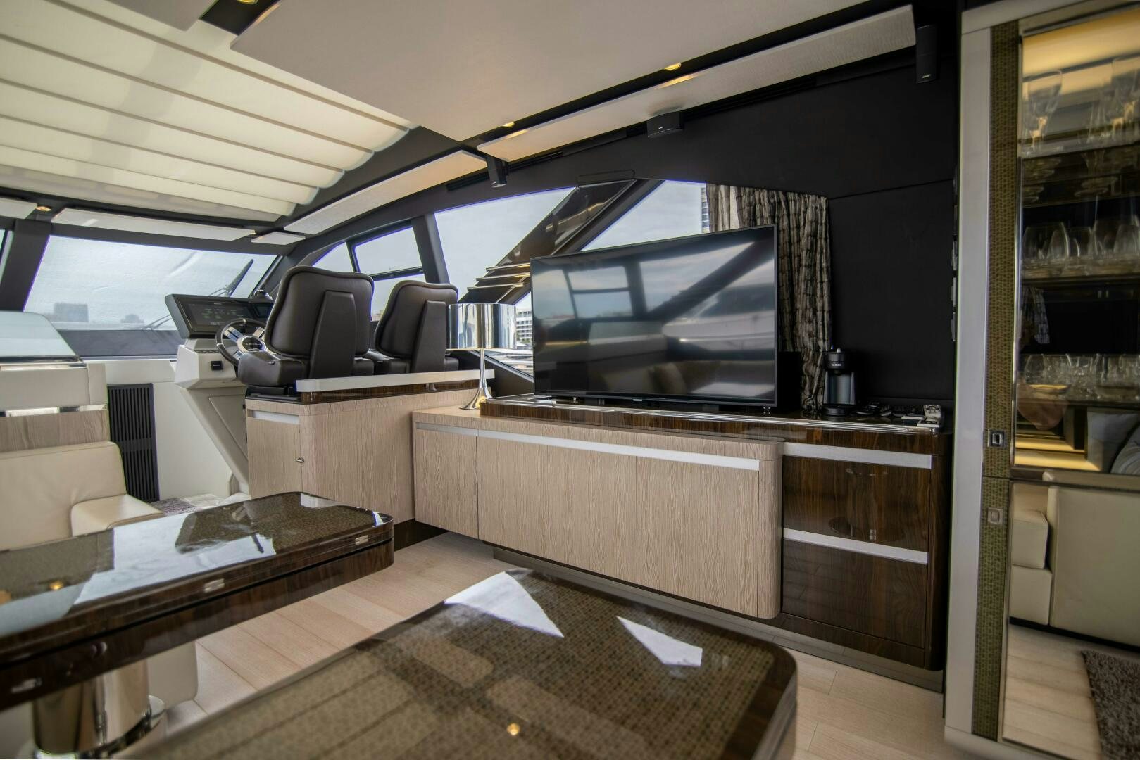 a room with a tv and a table aboard TRIPLE PLAY Yacht for Sale