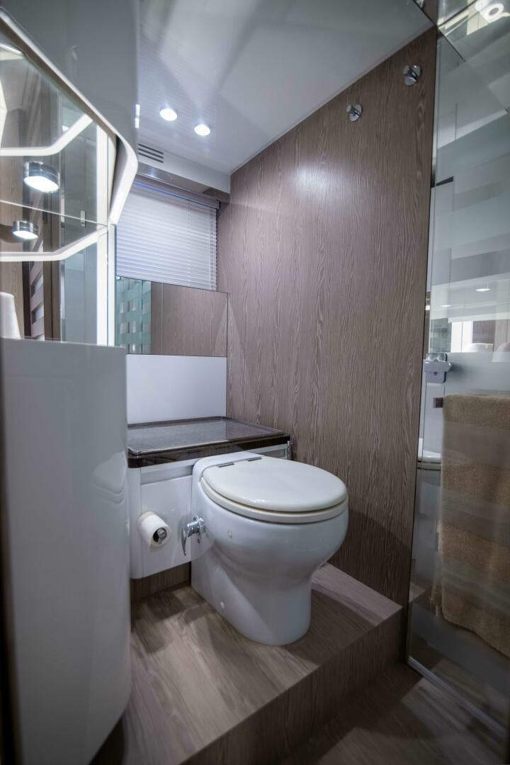 a bathroom with a toilet and a sink aboard TRIPLE PLAY Yacht for Sale