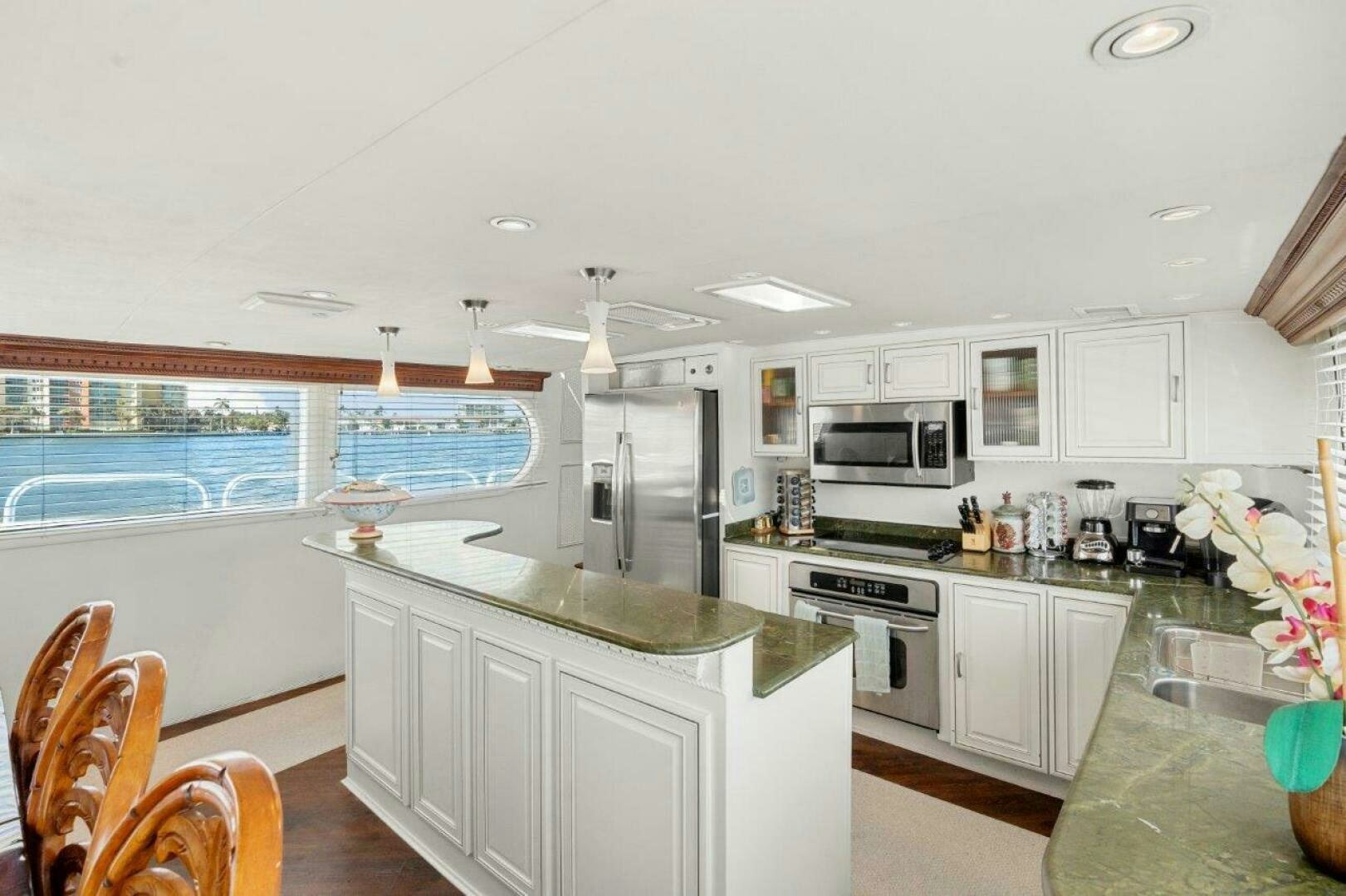 a kitchen with white cabinets aboard ENVISION Yacht for Sale